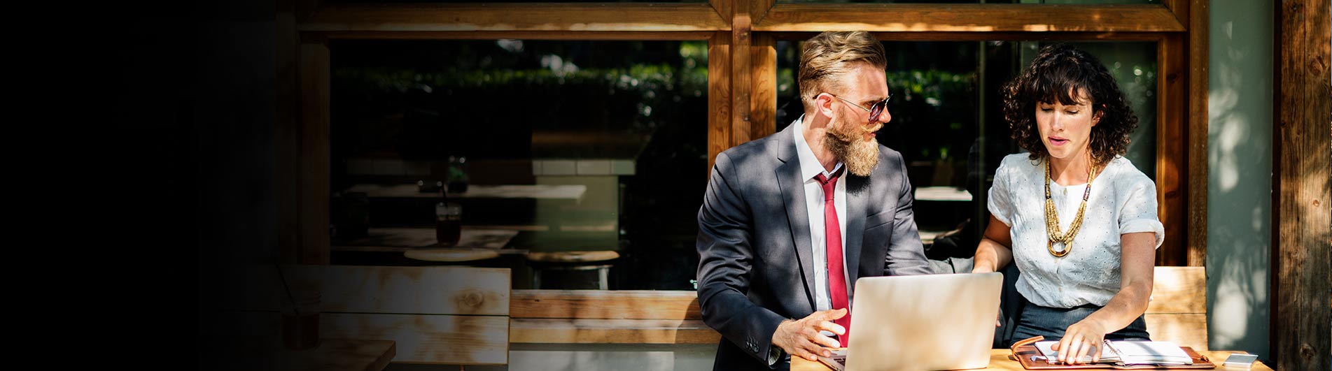 1 man in business suit and a woman talking to each other 